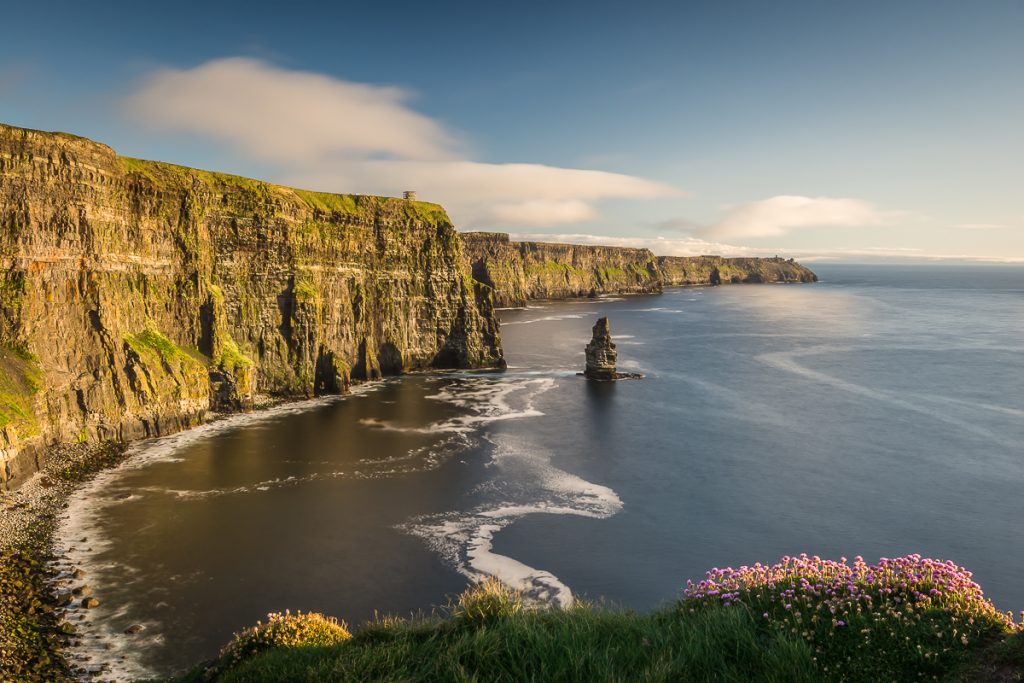 The Cliffs of Moher with it's famous sea stack and sea pinks in the foreground