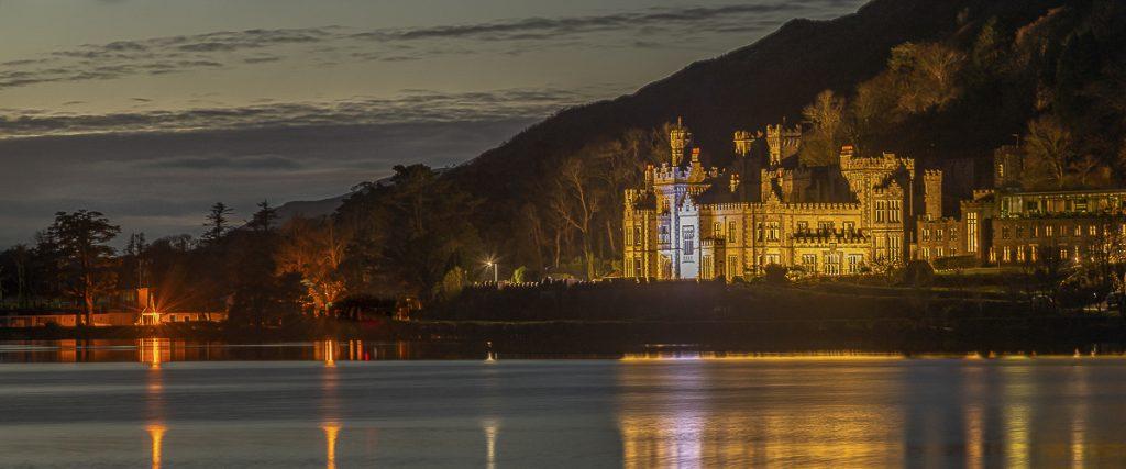 Floodlit Kylemore Abbey on the banks of Lough Pollucapal