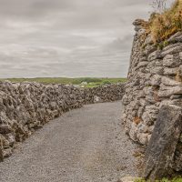 The stone wall of the fort and the outer stone wall. Burren fields in the background