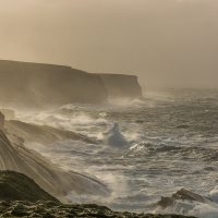waves pounding the cliffs at Kilkee at the end of a storm.