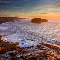 A large sea stack off the Kilkee cliffs at sunset