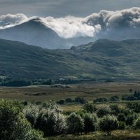 Cycling in Connemara, past cloud covered mountains and lush valleys